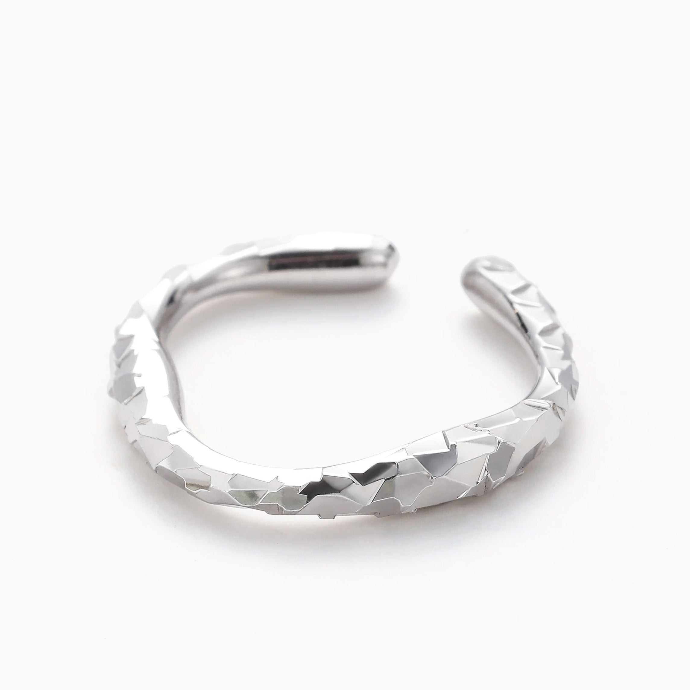 HIGH POLISH MACHINE CUT OPEN RING WITH FACETED TEXTURE