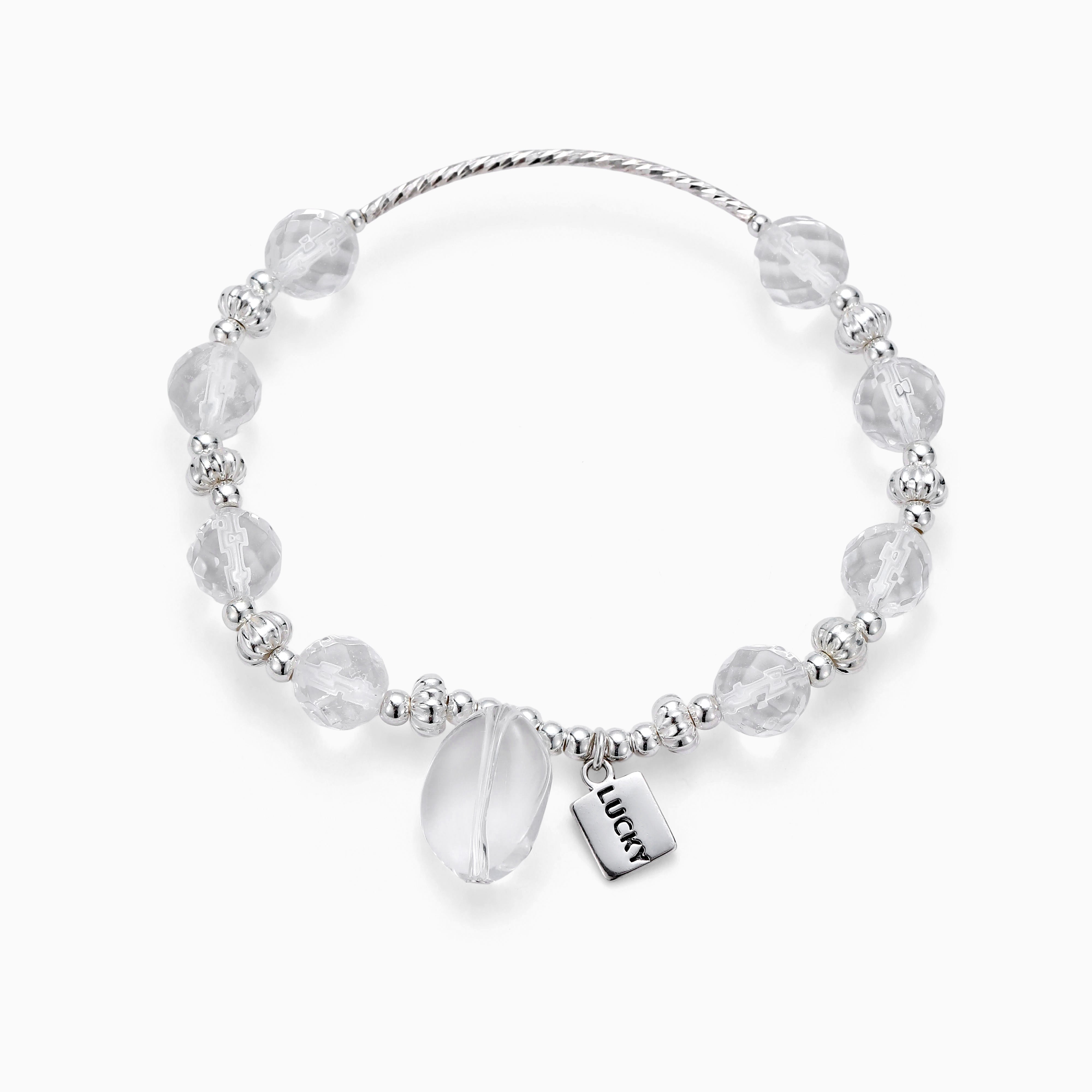 Clear quartz beads circle a sterling silver Lucky charm bracelet