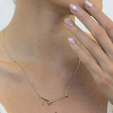 Sleek sterling silver chain necklace worn showing length