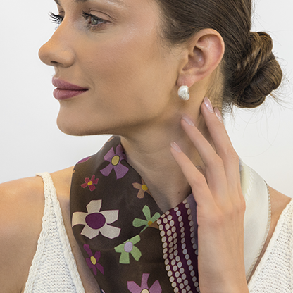 Heritage-style silver earrings demonstrating reversible design